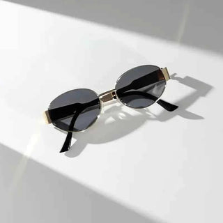 Elina – Ovale Damen - Sonnenbrille mit Metallrahmen und dunklen Gläsern - Cecile LavelleGold